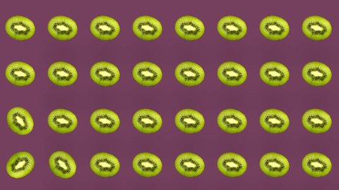 Colorful pattern of kiwi. Top view. Minimal tropical fruit concept. Seamless pattern with kiwi sliced. Pop art design. Realistic animation. 4K video motion
