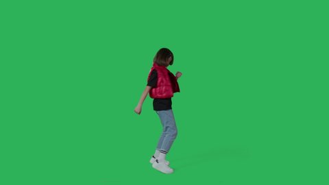 young beautiful girl dancing hip hop, dancehall, street dance over green screen background. Happy smiling child having fun on Chroma Key. 4k uhd video footage