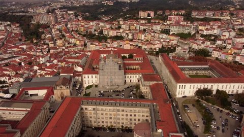 Aerial view above Coimbra Portugal historic old touristic Portuguese red coloured town rooftops