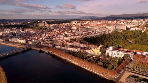 Cityscape of Coimbra in Portugal on sunny evening time, high altitude drone view