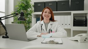Young redhead woman wearing doctor uniform and medical mask working at clinic - Powered by Shutterstock - Get 15% off with code: PIKWIZARD15