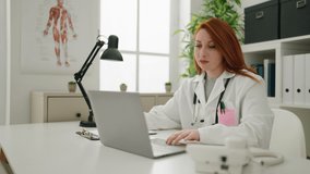 Young redhead woman wearing doctor uniform working at clinic - Powered by Shutterstock - Get 15% off with code: PIKWIZARD15