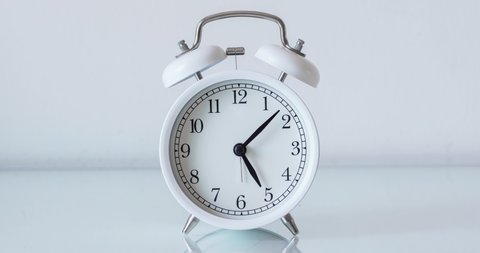 Alarm clock running time lapse on white background
