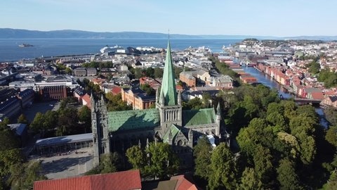 Trondheim Cathedral at golden hour by drone and the beautiful wooden houses. A famous piece of norwegian old architecture. Norway