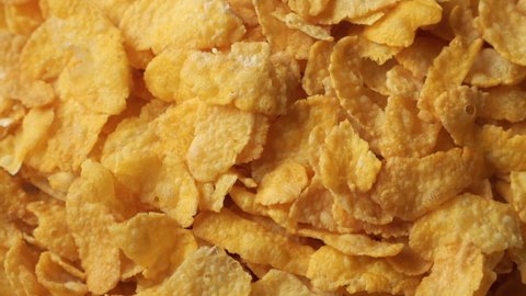 Golden dry corn flakes extreme close up rotating very slowly stock footage