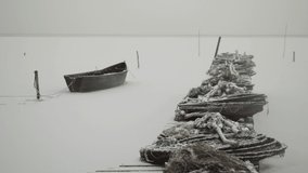 fishing boats and nets at shore in winter