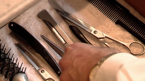 Barber Hands Opening Drawer and Picking Up his Tools at Beauty Salon or Barber Shop. Close Up.  