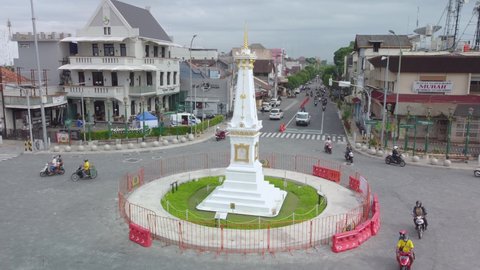 Jogjakarta, Indonesia - Dec 14, 2021: Busy Morning Street At White Paal (Tugu Jogja) an Icon of Jogja 