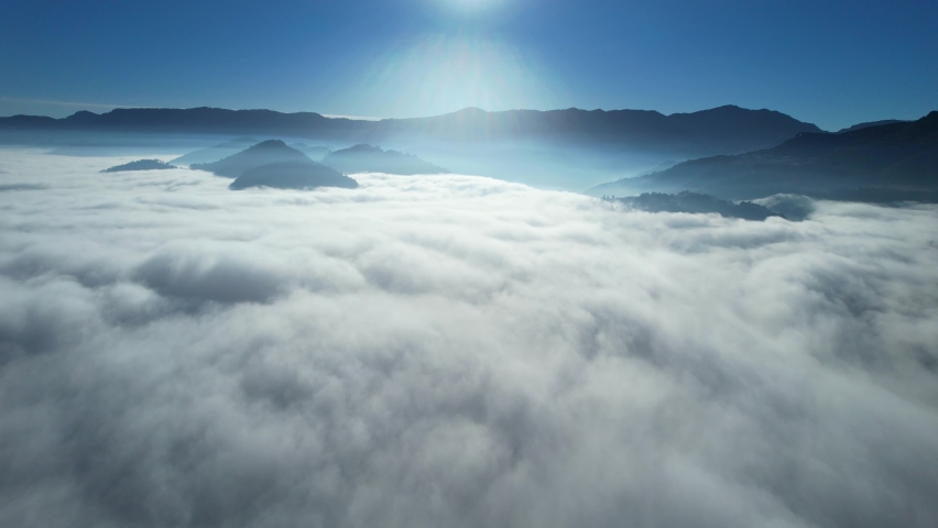 Drone Aerial View Flying Above Heavenly Beautiful Sunny Clouds Sunrise With Mountain Range In The Background. Royalty-Free Stock Footage #1085011759
