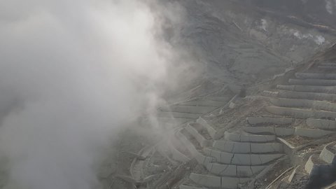 Looking down at fuming volcanic valley from a cable car (Owakudani, Hakone, Kanagawa, Japan)