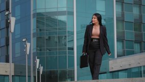 Young hispanic woman walking down street carrying briefcase looks around happy student girl jumps incendiary dancing passed exam funny businesswoman rejoices received dream job career advancement - Powered by Shutterstock - Get 15% off with code: PIKWIZARD15