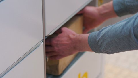 Collecting a parcel from a parcel locker in 4k slow motion