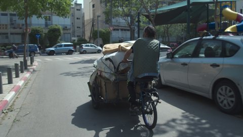 01.05.2020, Old Jaffa,Israel. Merchant carries the goods on a cart to the flea market in Jaffa
