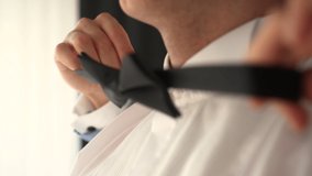 A man wears a black bow tie - Powered by Shutterstock - Get 15% off with code: PIKWIZARD15