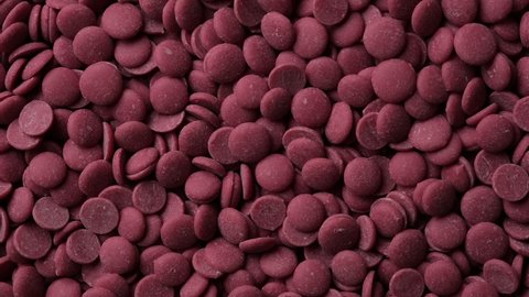Ruby chocolate chips top view rotation. Confectionery concept. 4K UHD video