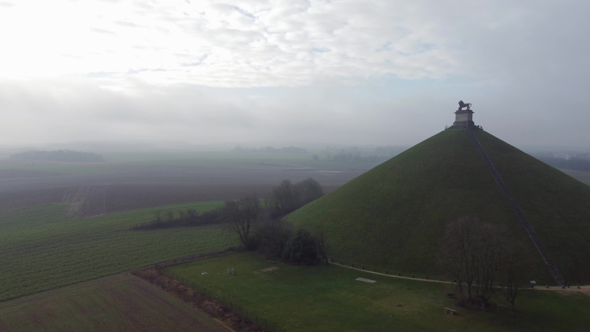 Drone aerial view of Butte du lion, the lion on a hill in Waterloo farmland where Napoleon was defeated. Cloudy winter day