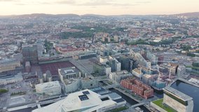Inscription on video. Oslo, Norway. Panoramic view of the city center during sunset. Railway station. Heat burns text, Aerial View, Point of interest
