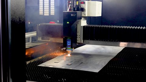 unidentified CNC operated laser cutting machine cutting metal sheet as per fixture on 8 January 2022 in a factory near Ludhiana, Punjab, India