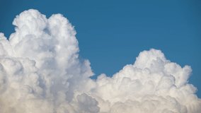 Timelapse of white puffy cumulus clouds forming on summer blue sky. Moving and changing cloudscape weather - Powered by Shutterstock - Get 15% off with code: PIKWIZARD15