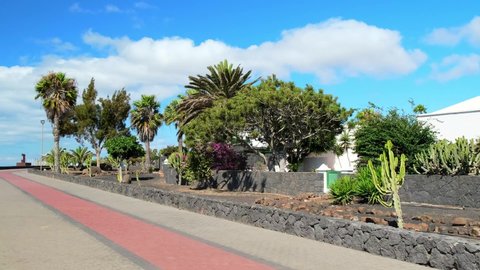 A beautiful empty promenade with palm trees and blue sky in Costa Teguise, Lanzarote, Canary Islands  COVID-19 Travel restrictions and Crisis 