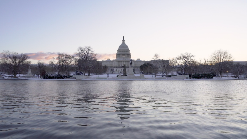 A 4k sunrise video of the US Capitol and reflecting pool right after a snowstorm. 