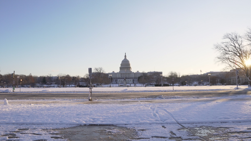 Washington DC, USA- January 7th, 2021: A 4k sunrise video of the US Capitol right after a snowstorm.