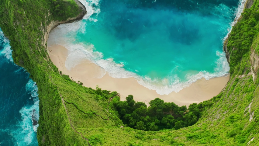 Kelingking Beach, Nusa Penida is one of the most incredible place for visit in Indonesia the eyes of travelers have a view amazing natural landscape, similar Jurassic world. Bali, Indonesia. 4K Aerial | Shutterstock HD Video #1085056670