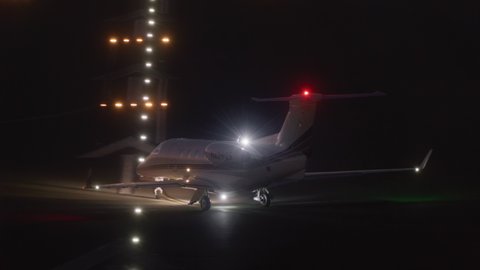 San Diego International Airport. 2021. Passenger airliner moving along the single runway airport. Plane preparing to take off within illuminated airport at night. High quality 4k footage