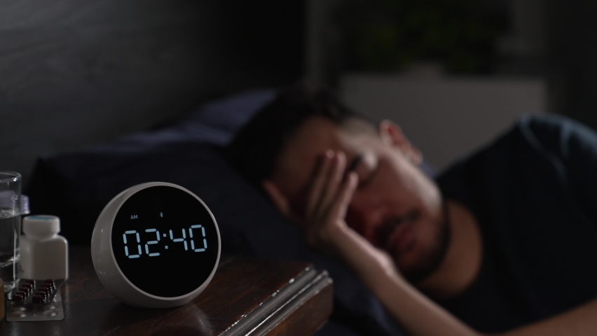 Depressed young Asian man sitting in bed cannot sleep from insomnia | Shutterstock HD Video #1085067740
