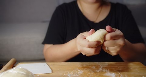 Close up hands of Asian woman pastry bakery chef preparing kneading soft dough making homemade bread using traditional recipe