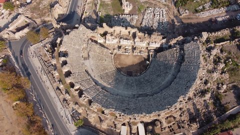 Top Aerial View of Ancient Greek Amphitheater Arena Construction in Side, Turkey. Antique Museum under Open Sky. Bird Eye Drone Shoot of History Heritage. World Famous Old Unesco Landmark.