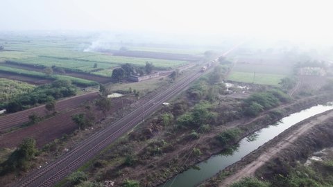 Aerial footage of a tanker train hauled by twin diesel locomotives at Uruli, near Pune India.