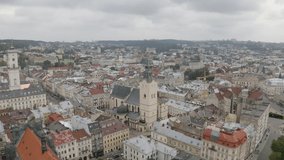 Aerial drone video of Latin Cathedral, city Lviv, Ukraine. Flight above roofs, streets. Panorama of ancient popular central part of old European town Lvov, Ukraine. Rynok Square, Central Hall, Ratusha