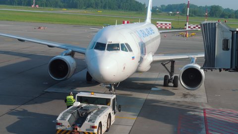 KALININGRAD, RUSSIA - JULY 28, 2021: Passenger plane of Ural Airlines departure at Khraborovo Airport, Kaliningrad (KGD). Passenger boarding is over. Departing flight on a summer day