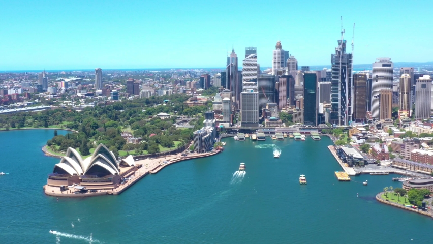 Aerial drone flyover above Sydney Harbour Bridge with views of Sydney City on a beautiful sunny day 