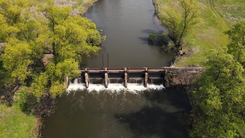 small dam by the river in the field. 4k drone footage