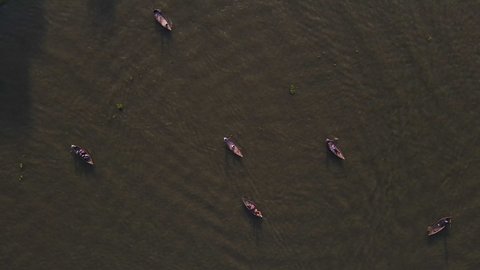 Wooden passenger boats for river crossing at Buriganga river - aerial top down drone ascending shot