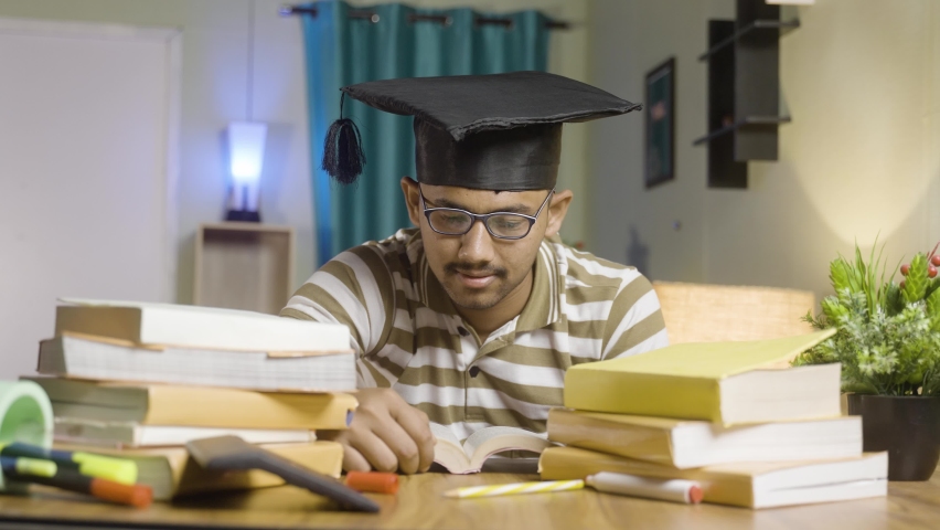 young student dreaming about graduation while studing book or preparing for examination at home - concept of daydreaming and future career goal and education.