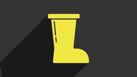 Yellow Waterproof rubber boot icon isolated on grey background. Gumboots for rainy weather, fishing, gardening. 4K Video motion graphic animation.
