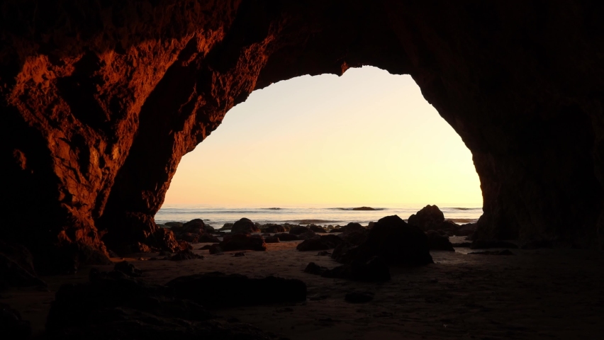 View of the ocean from inside a sea cave at Malibu California, El matador beach during golden hour