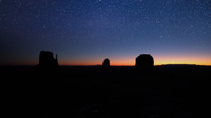 Sunrise time lapse at famous red rock formations landscape. Scenic road trip POV winter season in Monument Valley Arizona North America USA. Panoramic view butte mesa rocks in morning sunlight sunrise