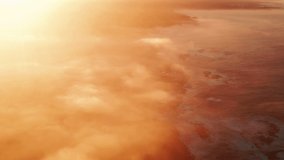 4K aerial majestic sunrise or sunset landscape. Amazing glowing light of nature cloudscape covering ocean coast. Heavenly golden orange clouds moving above water. Colorful sunrise clouds footage USA
