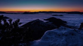 Beautiful view of winter sunrise in wild snowy mountains landscape with low foggy clouds in valley nature Time lapse Dolly shot - Powered by Shutterstock - Get 15% off with code: PIKWIZARD15
