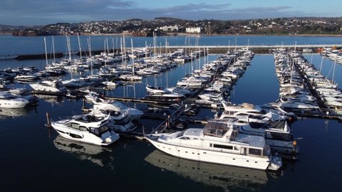 Torquay marina, Devon, England: Drone flyover view of moored yachts and cruise boats (MUTE)