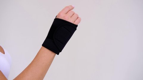 Black Wrist and Thumb Brace stabilizer on woman hand