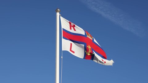 Aldeburgh, Suffolk, UK. January 2nd 2022. RNLI (Royal National Lifeboat Institution) flag flying at Aldeburgh Lifeboat Station.