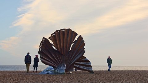 Aldeburgh, Suffolk. UK. January 2nd 2022. Time lapse of tourists visiting the Scallop sculpture on the beach.