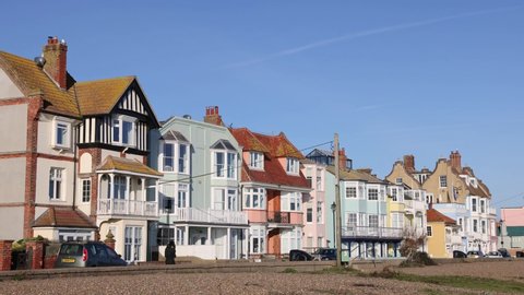 Aldeburgh, Suffolk. UK.  January 6th 2022. View of the coloured buildings on Crag Path facing the seafront on a sunny day with blue sky.  