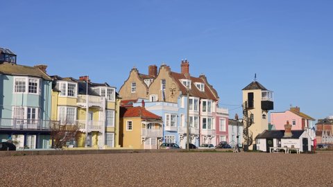 Aldeburgh, Suffolk. UK.  January 6th 2022. View of the coloured buildings on Crag Path facing the seafront on a sunny day with blue sky.  