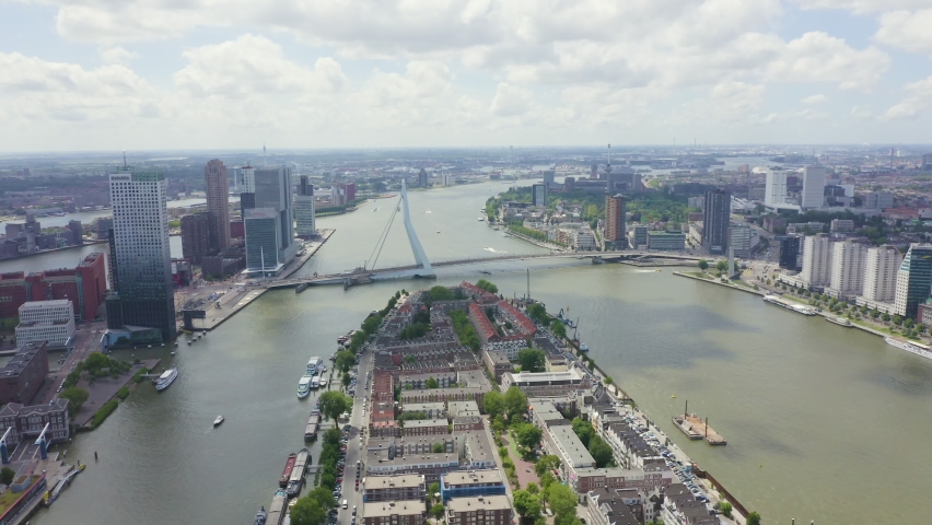 Inscription on video. Rotterdam, Netherlands. Norderayland Island ( North Island ) and Erasmus Bridge ( Erasmusbrug ) over the Nieuwe Maas River. Text furry, Aerial View, Point of interest